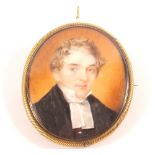 A Georgian miniature of head and shoulders of a gentleman in gilt framed hair backed brooch