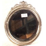 A circular Silver mirror with shell crest,