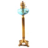 A Brass column oil lamp with blue glass bowl