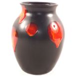 A Poole black ground vase with red and orange roundels