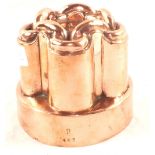 A Victorian circular Copper jelly mould of turret form, the tops linked with a chain,
