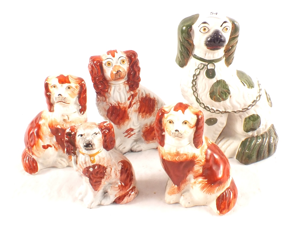 Four russet and one green Staffordshire dogs
