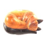 A carved wooden sleeping cat