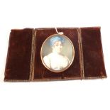 A 19th Century portrait miniature of head and shoulders of a lady in an oval gilt frame