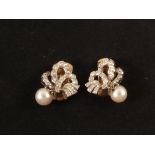 A pair of Gold and white metal (possibly Platinum) clip earrings in the form of stylised bows set