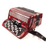 A cased Weltmeister button accordion,