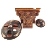 A carved Mahogany wall bracket and two African masks