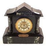 A black slate striking mantel clock