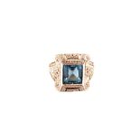 An impressive square cut Aquamarine set ring with large border scroll and pierced shoulders