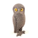 A metal owl pepper with glass eyes