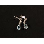 A pair of oval shaped Aquamarine and Diamond set earrings