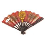 A Japanese iron painted fan with central gilded mask