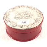 A Silver topped leather circular box with Millais cherub decoration,