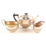 A Silver three piece half fluted tea set,