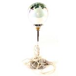 An Art Deco style chrome lamp with iridescent green glass shade