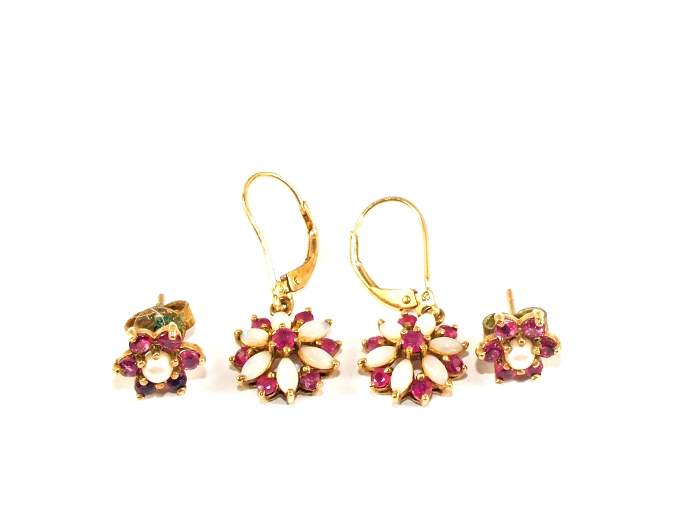 Two pairs of earrings both flower form,
