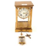 A Brass four glass mantel clock with painted enamel dial and mercury pendulum