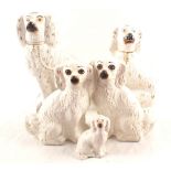 Five white glazed Staffordshire dogs