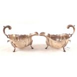 A pair of wavy rim Silver sauce boats,