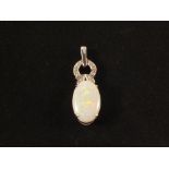 An oval shaped Opal pendant mounted in 9ct White Gold set with Diamonds