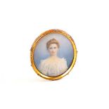 An oval portrait miniature of head and shoulders of a lady
