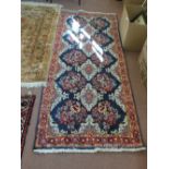 A Persian blue ground floral rug,