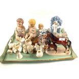 Four porcelain seated babies, figurines,