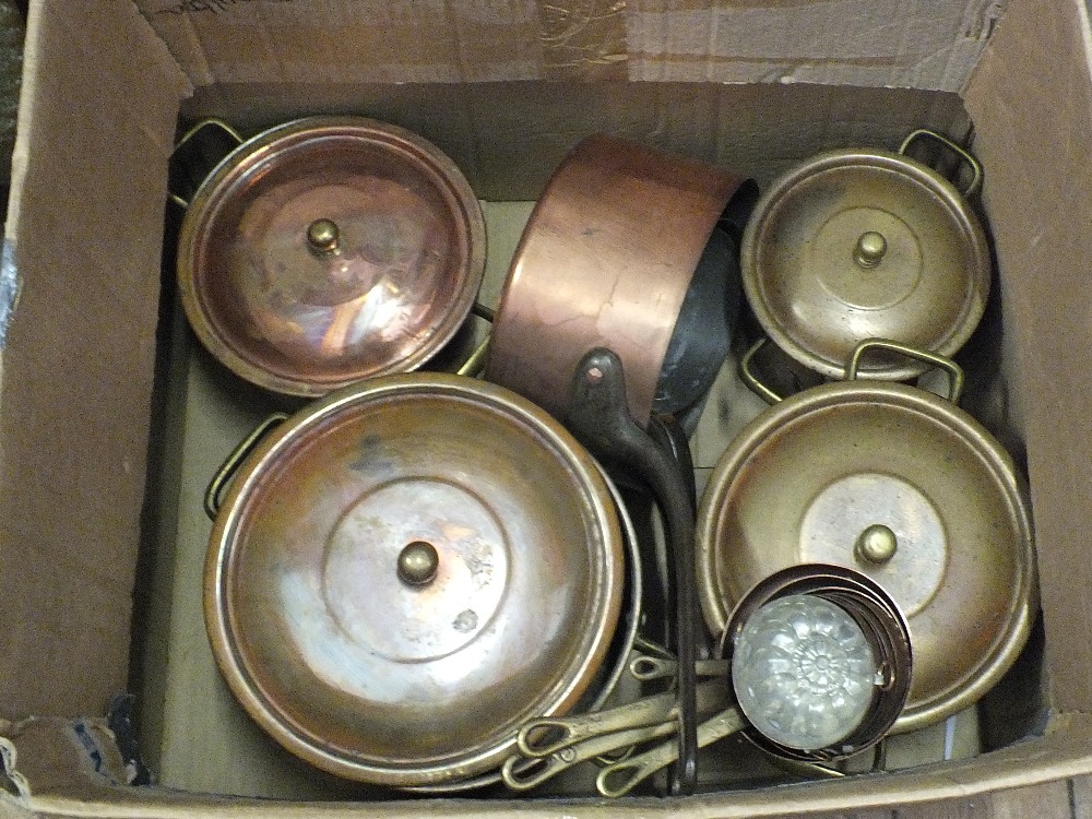 Four Copper lidded cooking pots,