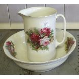 A rose decorated toilet jug and bowl