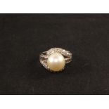 A White Gold ring stamped 14K set with a large Pearl with baguette and brilliant cut Diamond
