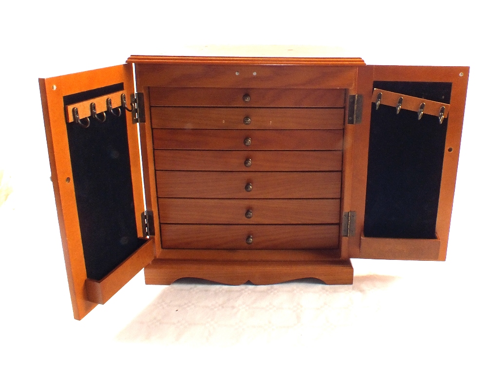 A modern seven drawer collectors cabinet