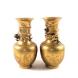 A pair of Chinese Brass vases with relief dragon decoration,