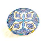 A Persian circular wall plate in blue and yellow