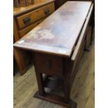 A rectangular Mahogany drop leaf table with a drawer at either end