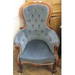 A Victorian Mahogany spoon back armchair with blue draylon button back upholstery on cabriole legs