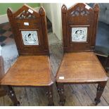 A pair of Victorian Gothic style hall chairs with inset tiled backs of Shakespearean scenes