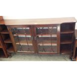 A Mahogany glazed two door cabinet flanked with open shelves,