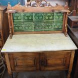 An Edwardian Satinwood washstand with green Art Nouveau tiled back and white marble top