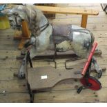 A vintage wooden rocking horse on later stand, dolls house,