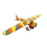 A Mettoy tin plate clockwork monoplane in camouflage colours
