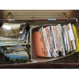 A suitcase of various postcards