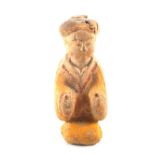 A Chinese Han Dynasty style pottery tomb figure retaining orange and red ochre decoration,