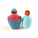 A Chinese light blue stone snuff bottle with red stone stopper,