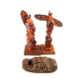 A pair of Native American miniature totem poles and a small mask