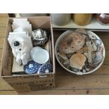 A box of various china plus a toilet bowl containing sea shells