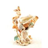 An Amphora shell vase supported by two Art Nouveau ladies,