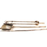 A substantial set of three heavy Arts and Crafts polished steel fire irons with barley twist shafts