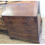 A Georgian Mahogany bureau with four graduated drawers and Brass drop handles on bracket feet