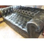 A dark green leather button back Chesterfield settee