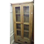 A light Oak two door display cabinet